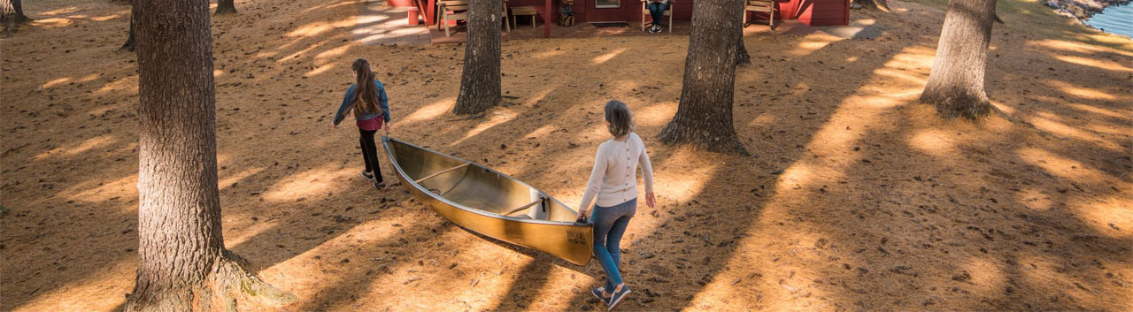 guests reading and carrying canoe