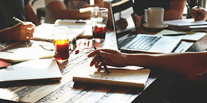 Close up of table with notebooks and a laptop